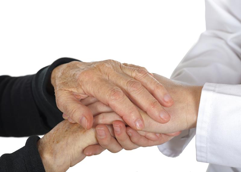 Individual holding an older person's hand
