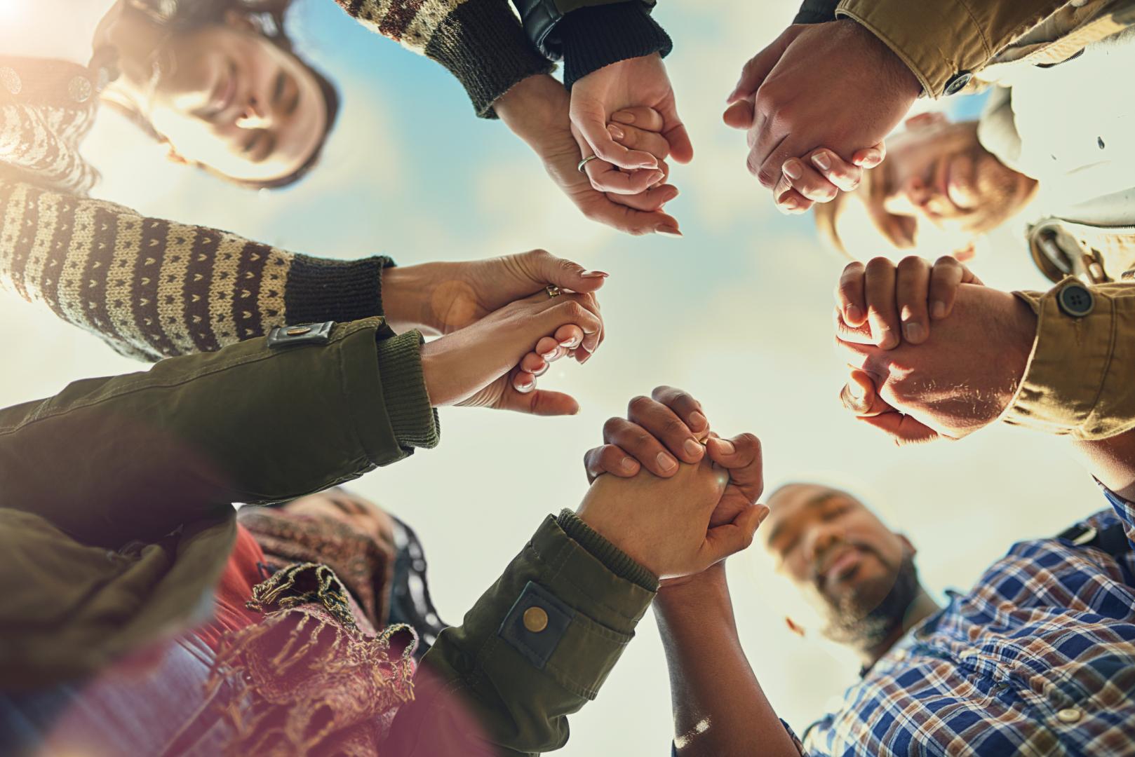 People handing hands in a circle