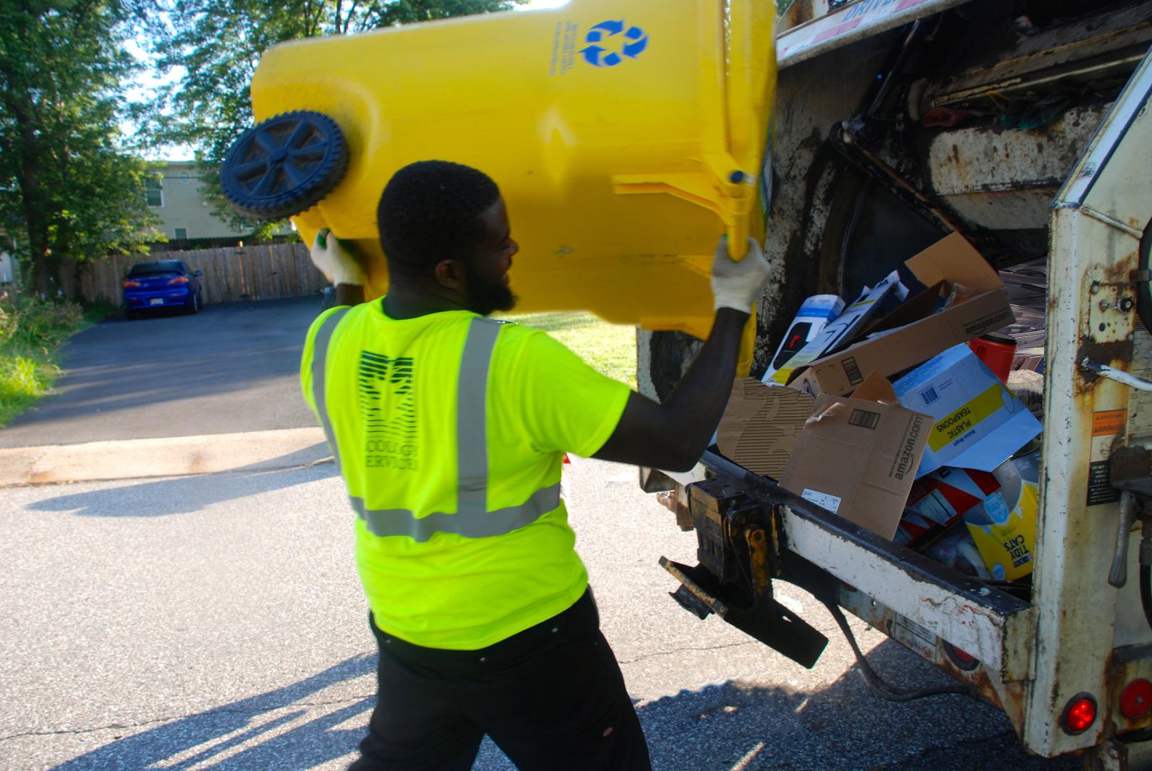 Worker Emptying Trash