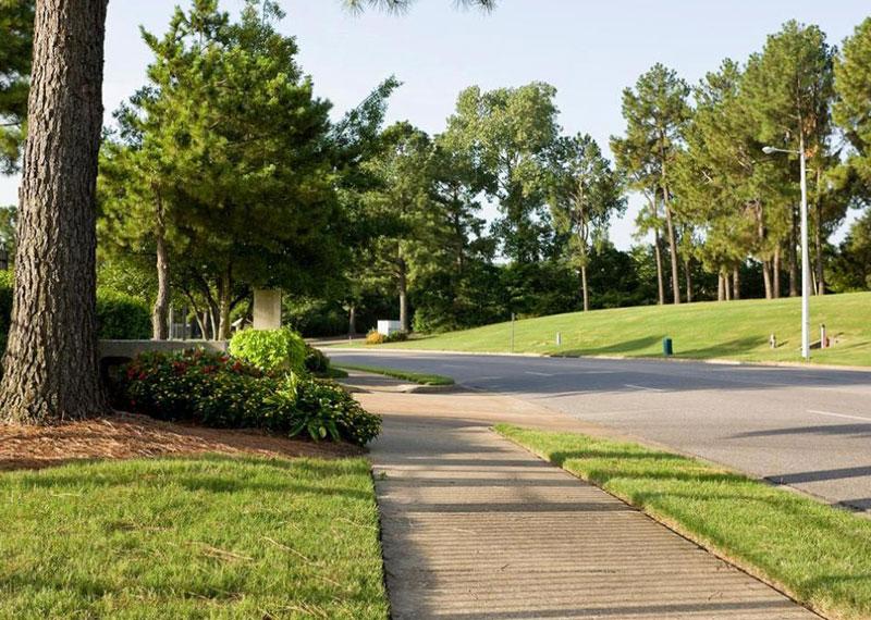 A sidewalk next to a road