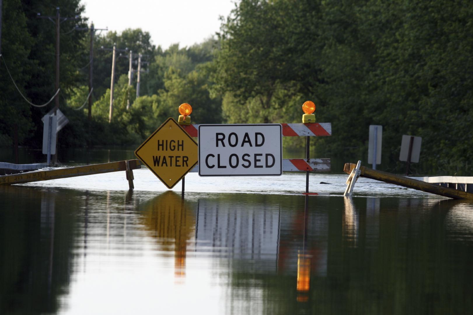 flooded road with road closed sign