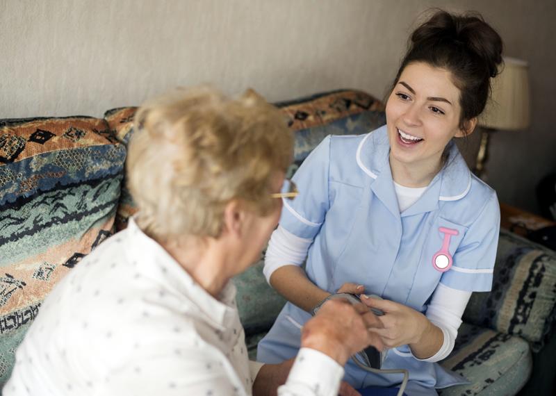 Nurse helping older woman