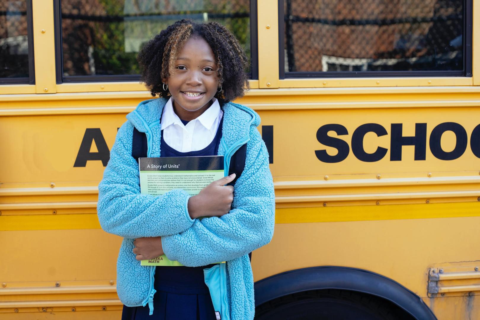 Child in front of school bus