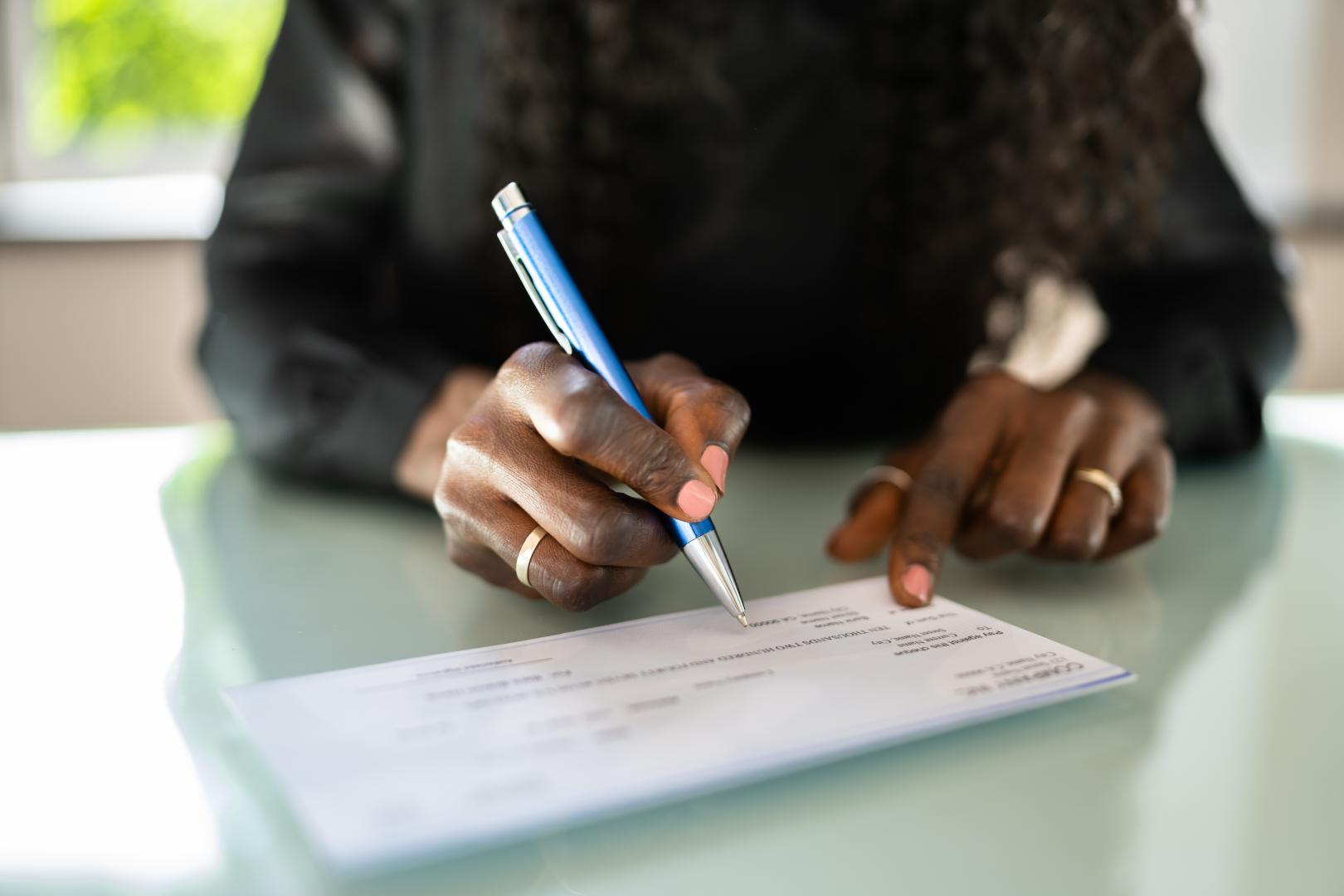 Person Writing a Check