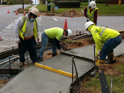 Team working on laying a sidewalk