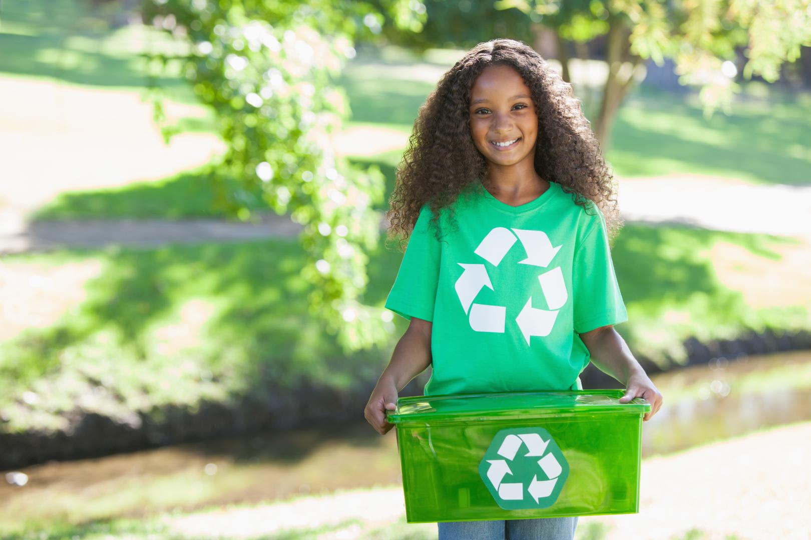 Girl holding a recycling container
