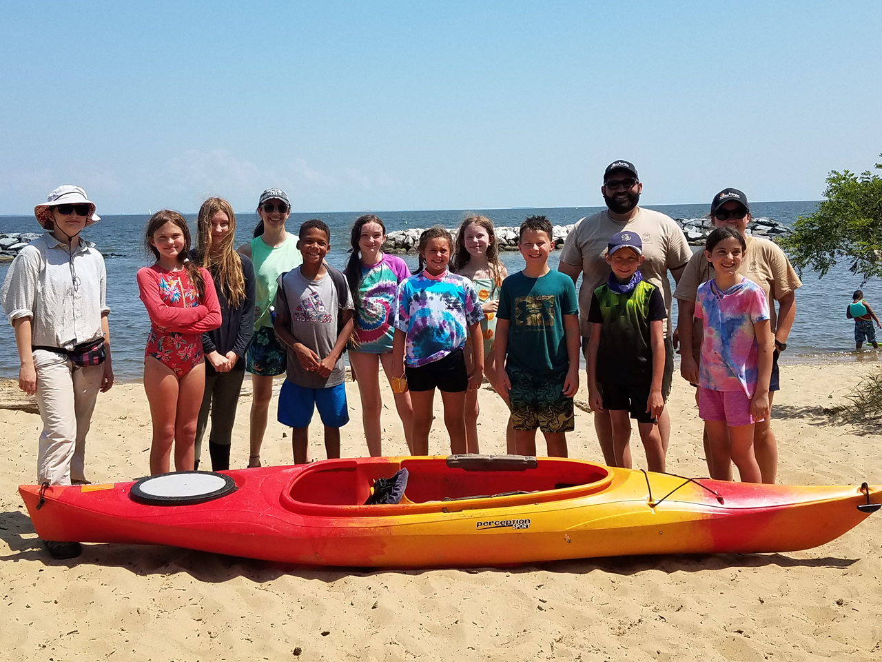 Children in front of kayak