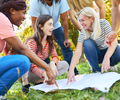 Small group of women pointing on a map