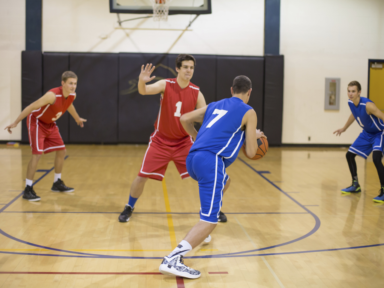Men playing basketball indoor court