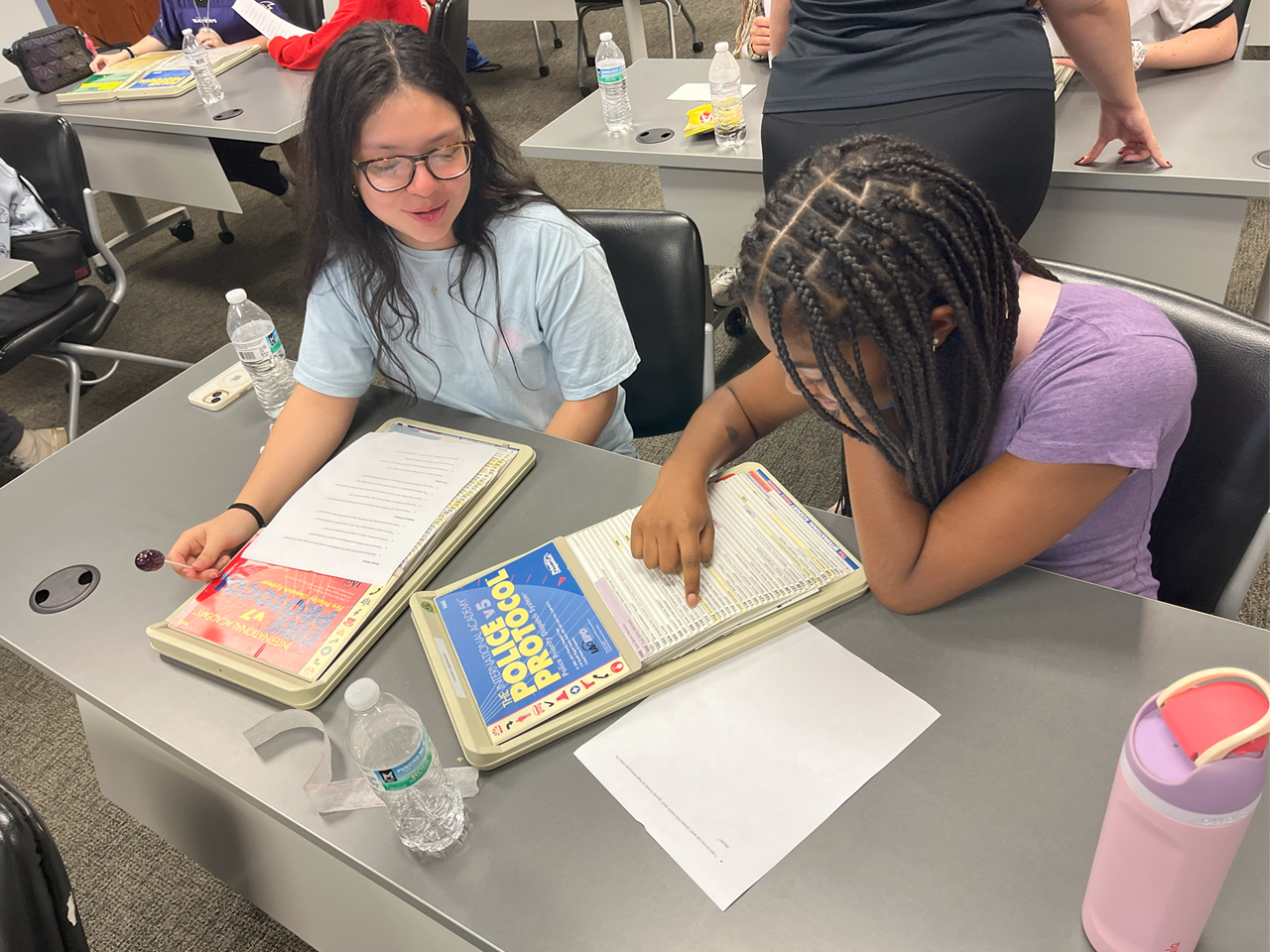 Young ladies at desk with related paperwork