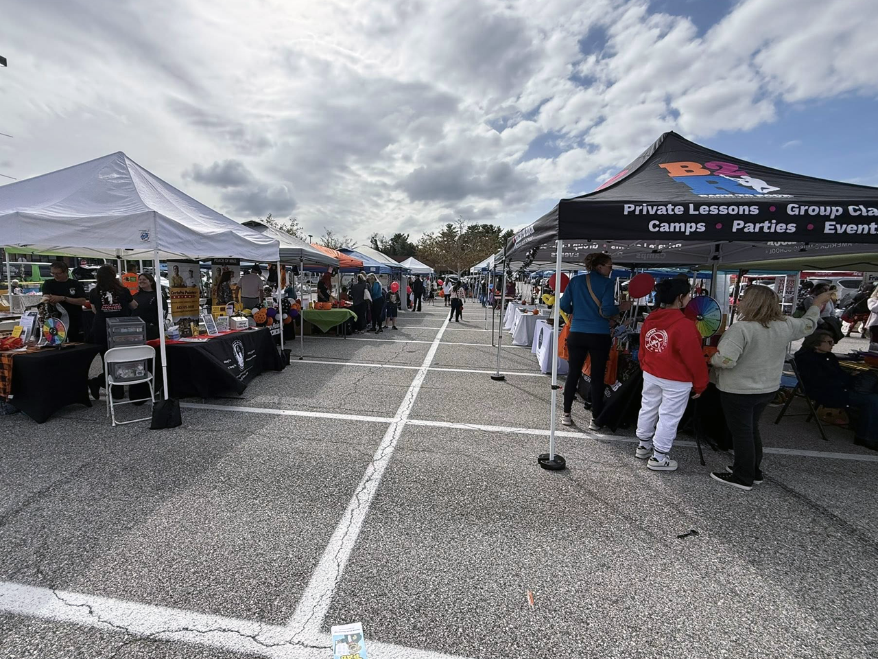 Parking lot with vendors under tents