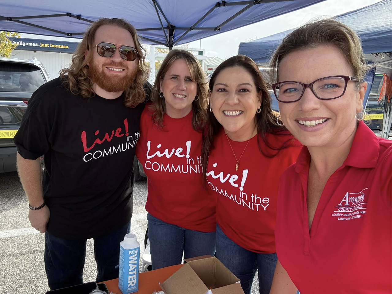 Four people outside at an outdoor festival