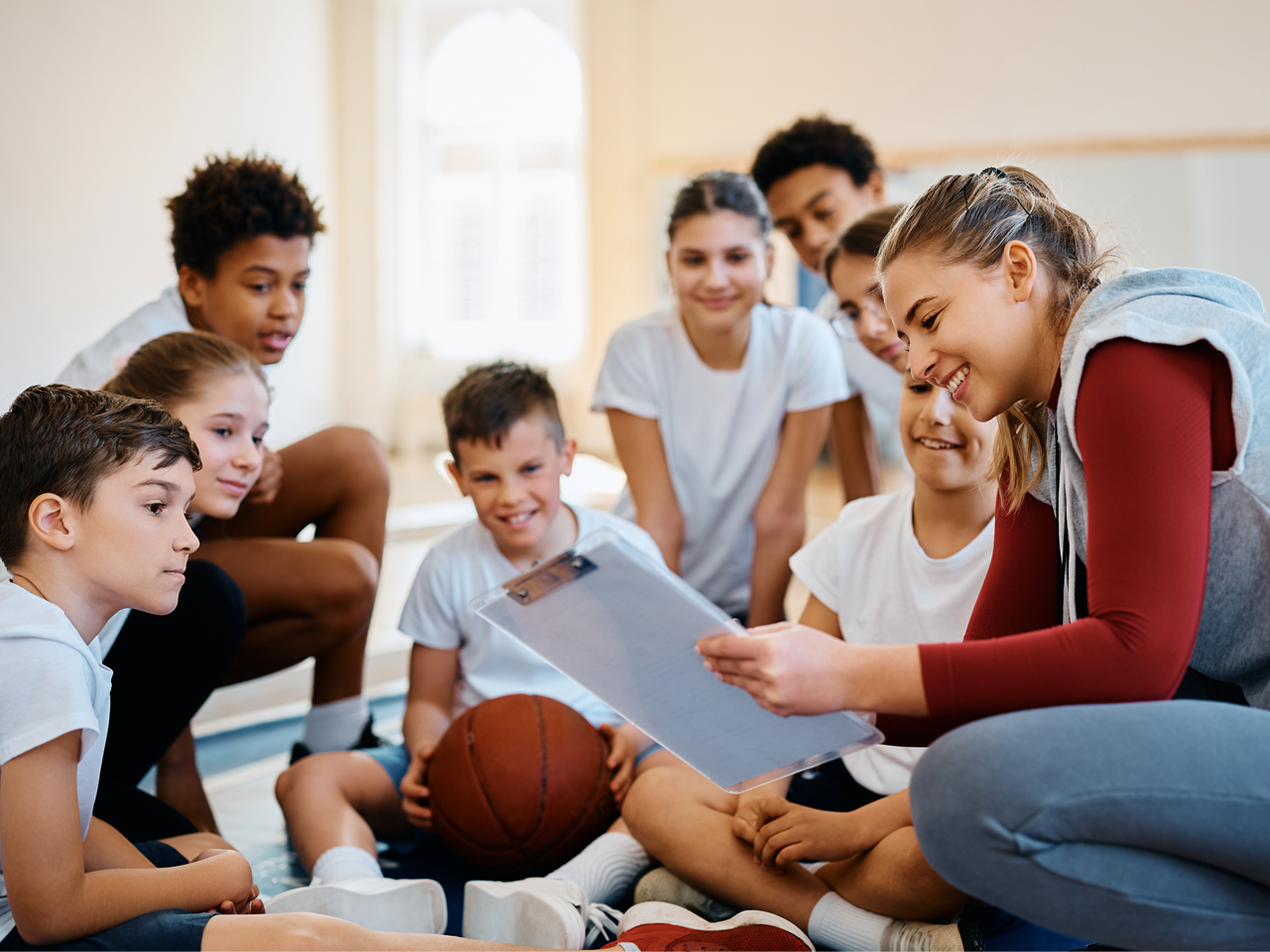 Girls and Boys Baskeball Players with their Coach