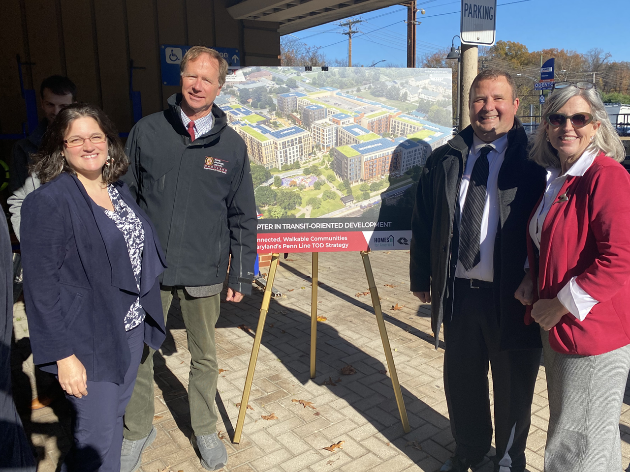 Group of people near an outdoor sign