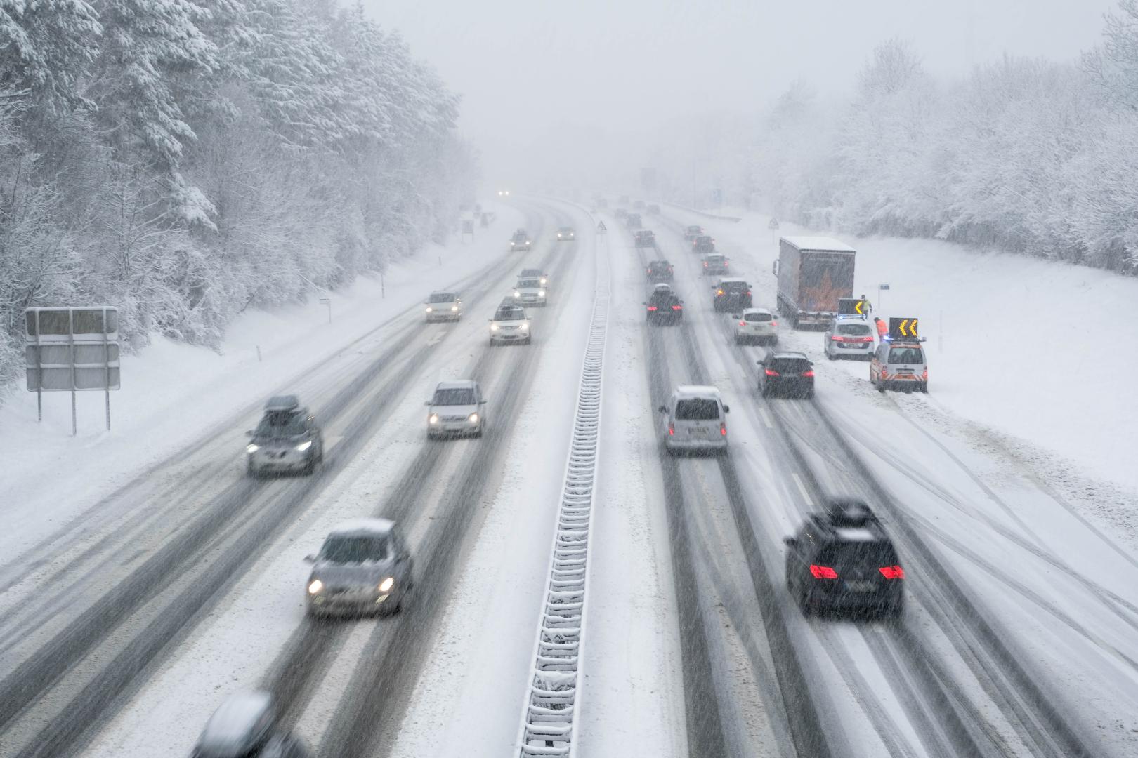 Cars driving on a snowy highway