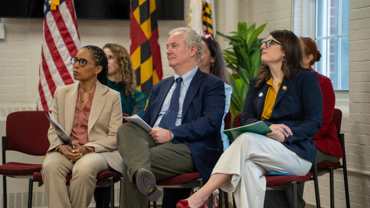 Elected representatives seated listening to remarks