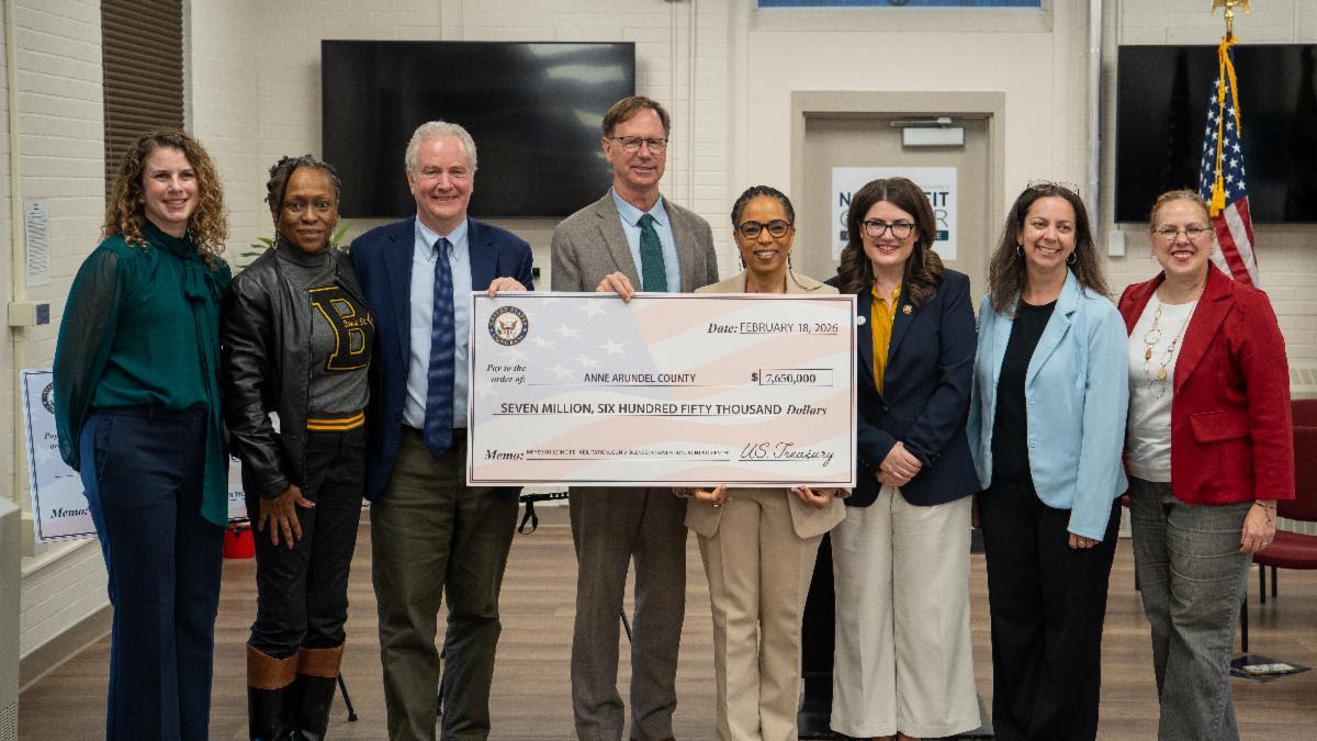 Elected officials holding up check 