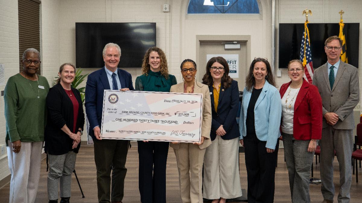 Elected officials holding up check for food bank