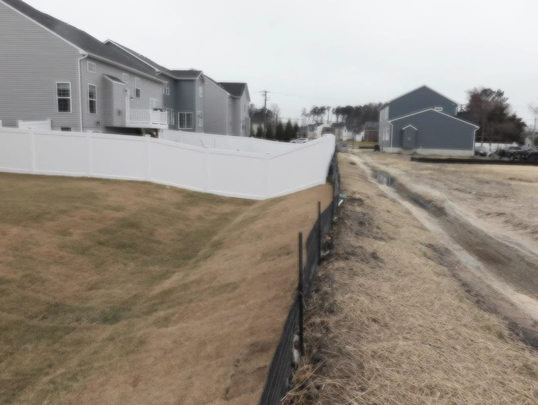 An example of a practical and homeowner conflict (e.g., fencing, decks, and privacy issues) where a homeowner-installed fence blocks an entire Bio-swale, which is still under construction.