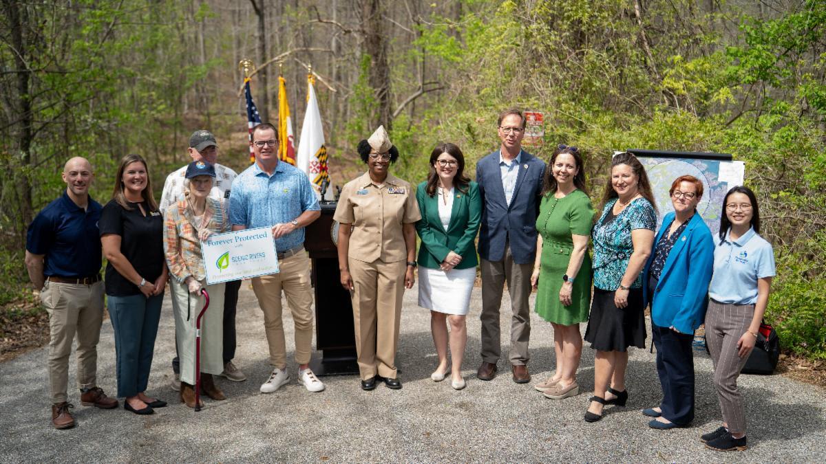 Group of attendees standing in a semicircle