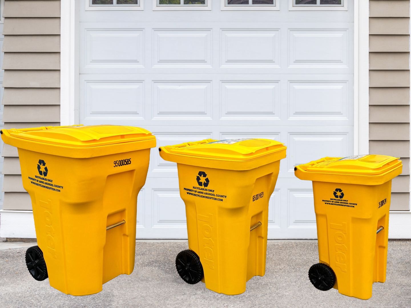 Three yellow recycling carts in front of a garage door