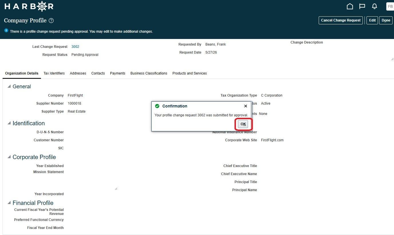 A "Confirmation" dialog box centered over the "Company Profile" screen on the HARBOR portal. The popup message reads, "Your profile change request 3002 was submitted for approval," accompanied by a green checkmark icon. A red rounded rectangle highlights the "OK" action button inside the dialog box. The blurred background displays general organization details for a company named "FirstFlight", along with metadata showing the request status is now marked as "Pending Approval."