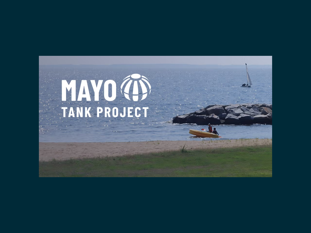 A body of water with the words Mayo Tank Project floating on top of  it