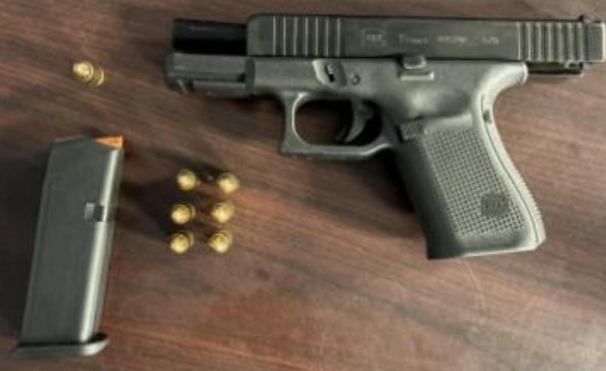 An image of a firearm and bullets.