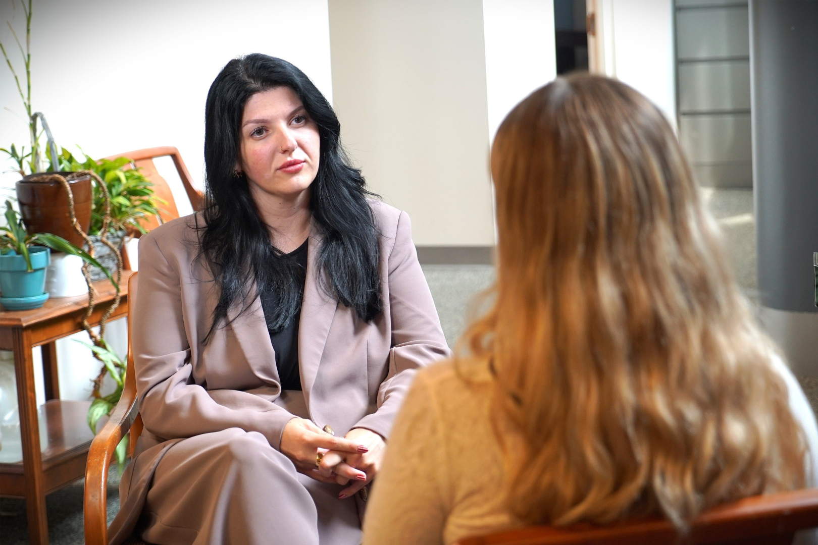 Two women talking in an office setting