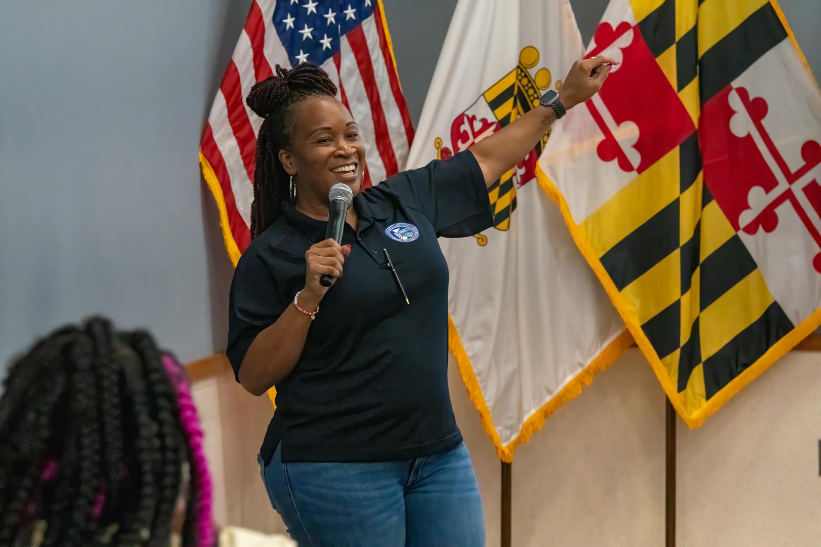Instructor on the microphone during HERoes on the HERizon Camp