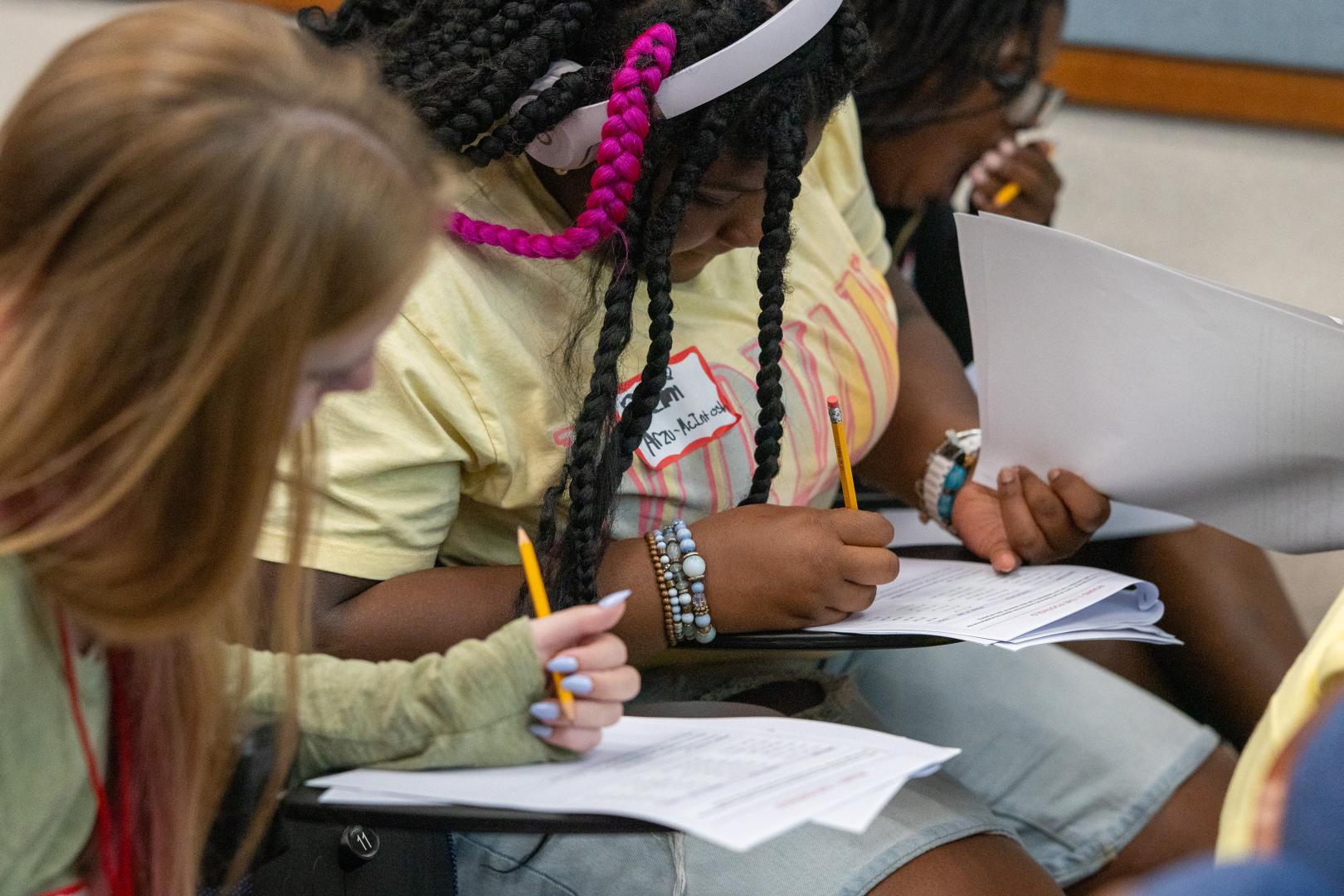 Participants taking notes during HERoes on the HERizon Camp 