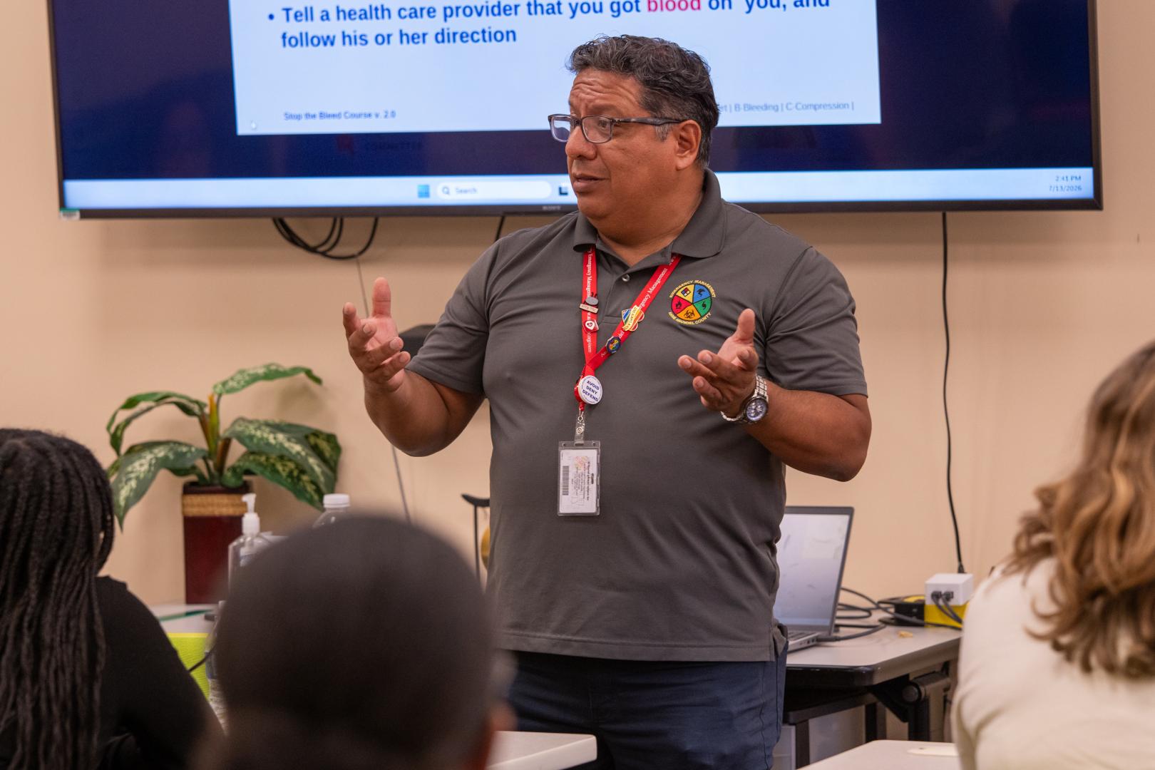 A speaker addressing a group of young campers sitting in an audience at the HERoes on the HERizon leadership event.