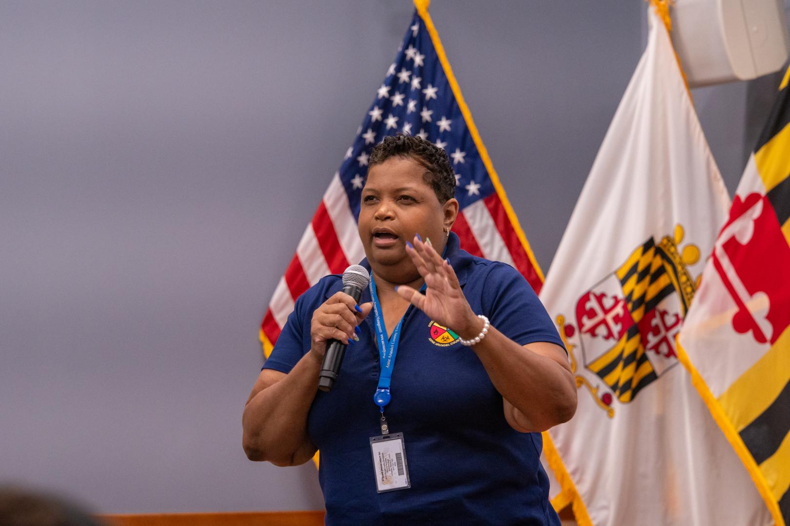 A speaker addressing a group of young campers sitting in an audience at the HERoes on the HERizon leadership event