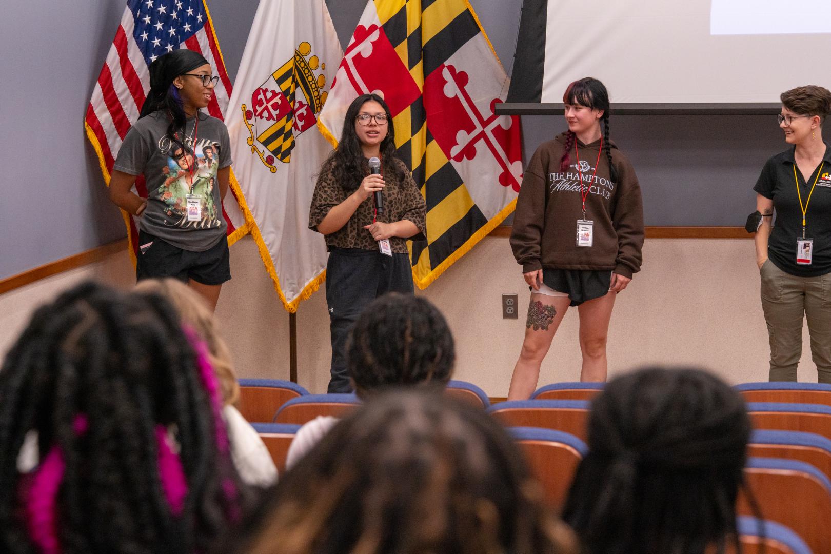A speaker addressing a group of campers at the HERoes on the HERizon leadership event