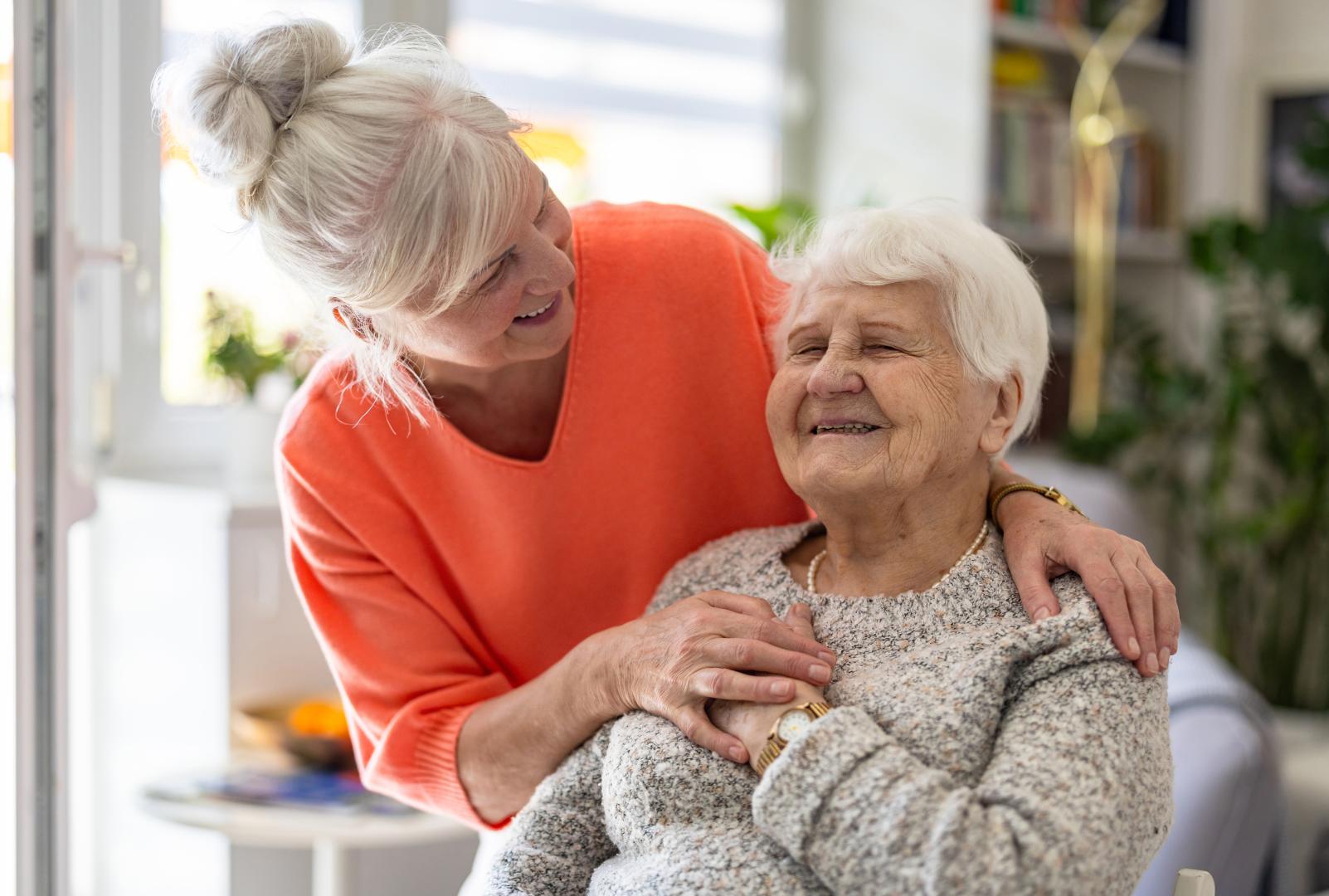 Female home caregiver providing emotional support to an elderly woman